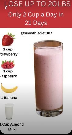 a glass filled with milk and strawberries next to a banana