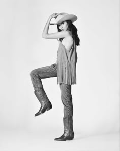 black and white photo of woman in cowboy outfit