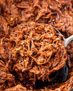 shredded meat in a bowl with a spoon