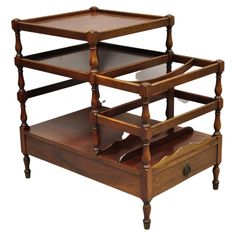 three tiered wooden tray with drawers on each side and one drawer at the bottom