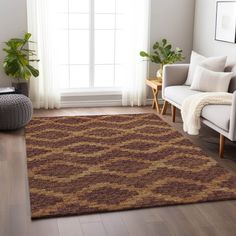 a living room with a couch, chair and rug on the hardwood floor next to a window