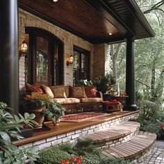 a porch with lots of plants and flowers on it