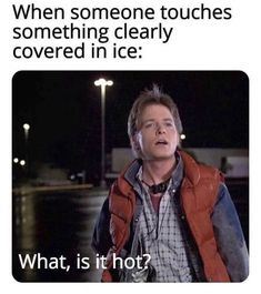 a man in an orange vest is talking on his cell phone with the caption, when someone touches something clearly covered in ice