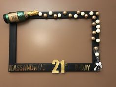 a frame with pearls and a bottle of champagne on it that says kassandra's 21st birthday