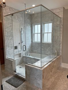 a bathroom with a walk in shower next to a bath tub