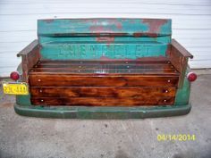 an old wooden bench sitting in front of a garage door