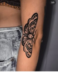 a woman's arm with a black and white butterfly tattoo on the left side