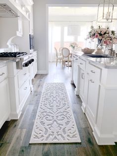 a white rug in the middle of a kitchen