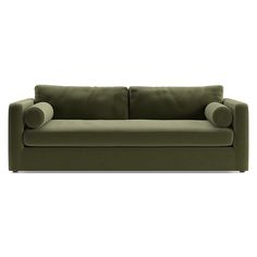 a green couch sitting on top of a white floor