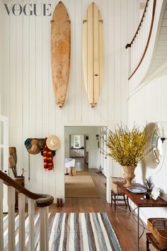 there are two surfboards hanging on the wall