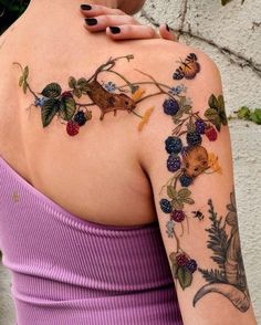 a woman with tattoos on her arm and shoulder