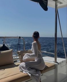 a woman sitting on the back of a boat