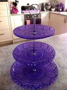 three tiered purple glass cake stand in a kitchen