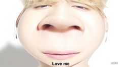 a close up of a person's face with the words love me on it