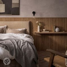 a bed sitting in a bedroom next to a wooden table