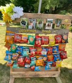 a wooden stand with bags of chips on it