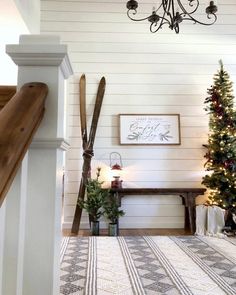 a christmas tree is in the corner of a room with white walls and wood trimmings