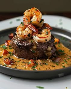 a steak with shrimp and sauce on it