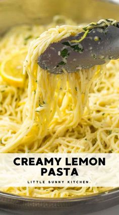 a spoon full of creamy lemon pasta being lifted from a skillet with the words, creamy lemon pasta