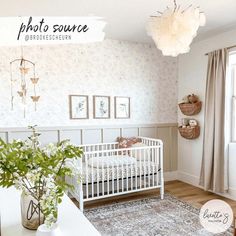 a baby's room with a white crib and floral wallpaper on the walls