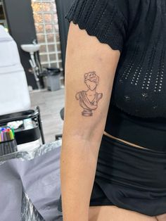 a woman with a small tattoo on her arm