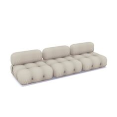 a white couch with four pillows on it