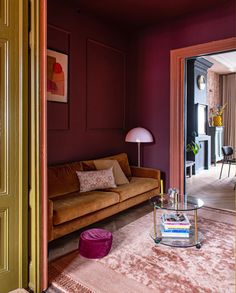 a living room with purple walls and furniture