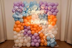 a birthday balloon arch with balloons on it