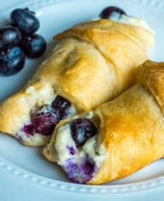 two croissants on a plate with blueberries