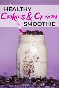 a mason jar filled with cookies and cream smoothie on top of a purple surface