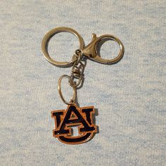 Nwt.....Auburn University Keychain/Bag Charm. Silver Tone, And Auburn Orange And Blue Color. Approx Measurements 3.5" Long Auburn University, Key Card Holder, Chain Bags, Auburn, Blue Orange, Chloe, Silver Tone, Blue Color, Women Accessories