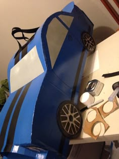 a car made out of cardboard sitting on top of a table