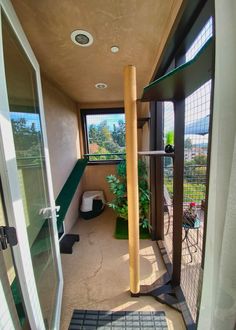 the inside of a house with an open door and some plants on the outside wall