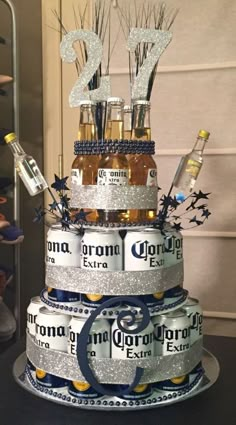 a cake made to look like it is stacked with beer bottles and sparklers on top