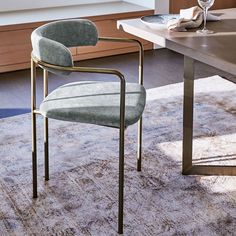 a chair sitting on top of a rug in front of a desk with a window