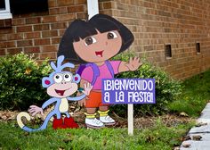 there is a sign with a cartoon girl and monkey on it in front of a brick building