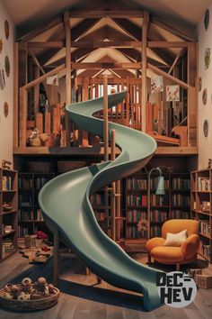 an indoor play area with a slide and bookshelves