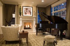 a living room filled with furniture and a grand piano in front of a fire place