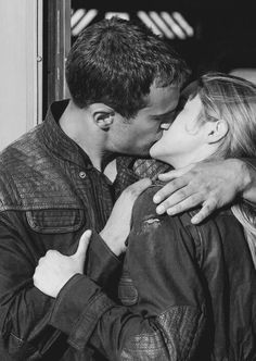 a man and woman kissing each other in front of a colorful background with the words love on it