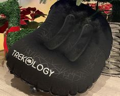 an inflatable bag sitting on top of a table next to a christmas tree