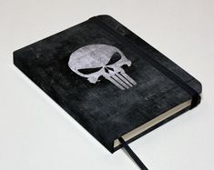 a black notebook with a skull on it