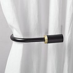 a white curtain with a black handle on it