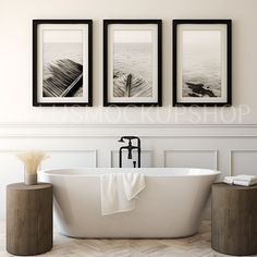 three black and white pictures hang on the wall above a bathtub