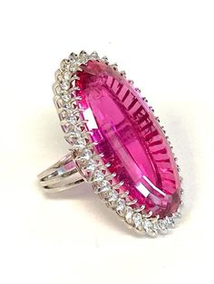 Platinum Pink Tourmaline & Diamond Cocktail Ring DescriptionPlatinum Ring; 1 Oval Pink Tourmaline 31.11 Carat; 37 Round Brilliant Cut Diamonds 1.48 Carat Total Weight, SI-1, I-J; Finger Size 5 1/2; 19.7 Grams. #BarbieRing#Barbie#BarbiePink Payment All payments must be made through PayPal, NO EXCEPTIONS. We cannot accept payment plans. We do not offer Layaway. Shipping We ship via USPS Registered Mail, Return Receipt in order to provide tracking and insured delivery, which usually takes 5-7 days Ruby Party Ring, Dazzling Oval Rings For Party, Party Ruby Gemstone Rings, Party Rings In White Gold With Gemstone, Party White Gold Gemstone Rings, Oval Party Ring With Center Stone, Pink Gemstone Party Ring, Formal Pink Rings With Polished Finish, Oval Gemstone Party Rings