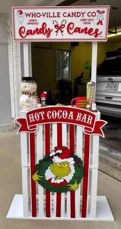 a candy bar sign sitting in front of a building