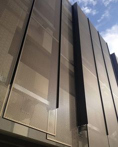 the side of a building with metal mesh covering it