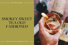 a person holding a glass with an orange peel in it and the words smokey sweet tea old fashioned