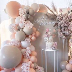 balloons and flowers are on display in front of a backdrop