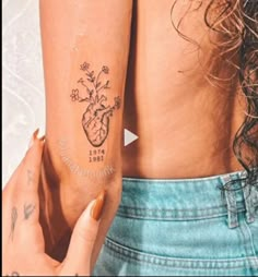 a woman's arm with tattoos on it and the word love is in front of her