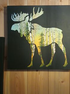 a moose is painted on the side of a wood paneled wall with pine trees